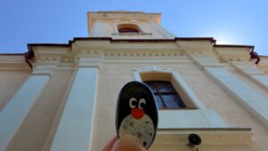 Hand-painted penguin stone #1148 hidden at Church of St Bartholomew the Great, Hniezdne, Slovakia