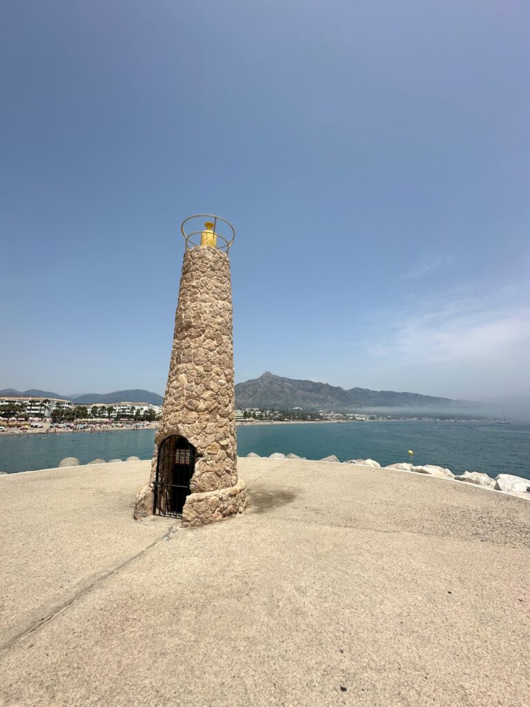 Hand-painted penguin stone #1158 hidden at Playa de Puerto Banús, Marbella, Spain (photo 3 of 5)