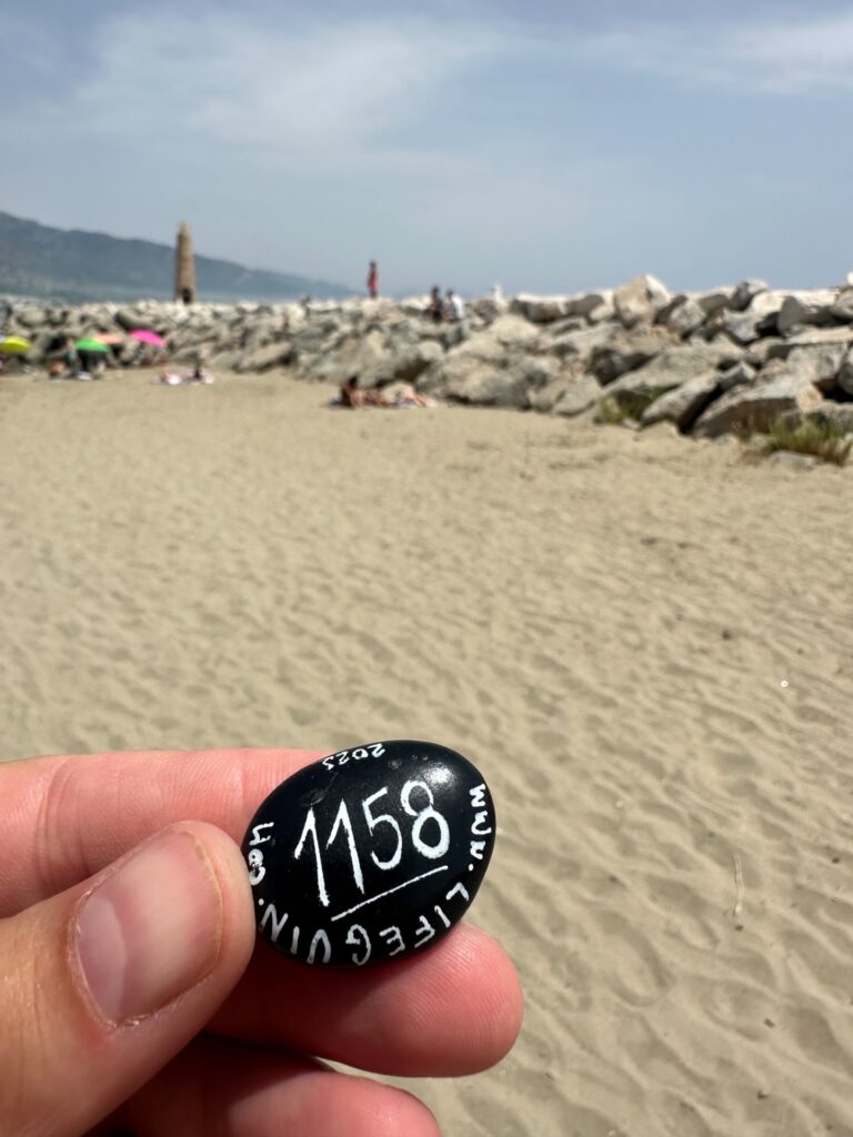 Hand-painted penguin stone #1158 hidden at Playa de Puerto Banús, Marbella, Spain (photo 5 of 5)