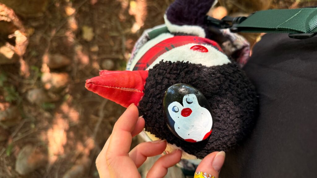 Hand-painted penguin stone #1301 hidden at Tree Trunk, Lednice, Czechia (photo 3 of 4)