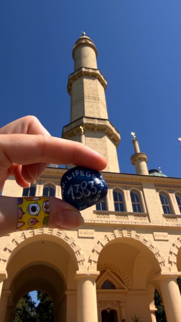 Hand-painted penguin stone #1383 hidden at Lednice Minaret, Lednice, Czechia (photo 2 of 5)