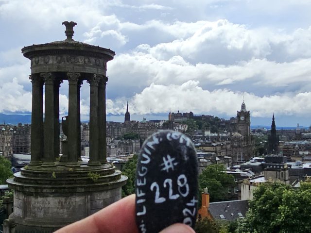 Hand-painted penguin stone #228 hidden at Dugald Stewart Monument, Edinburgh, United Kingdom (photo 4 of 5)