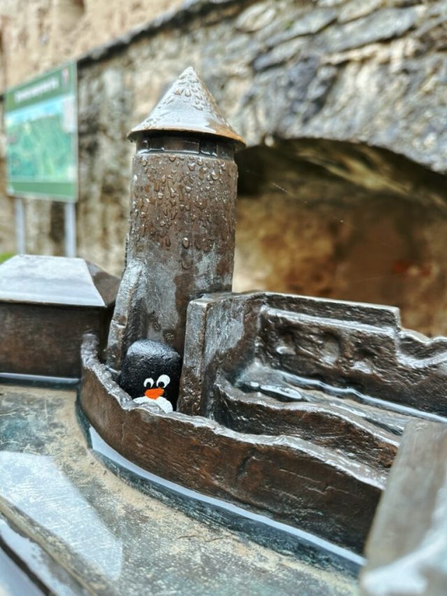Hand-painted penguin stone #204 hidden at Castle Garden, Stara Lubovna, Slovakia (photo 5 of 5)