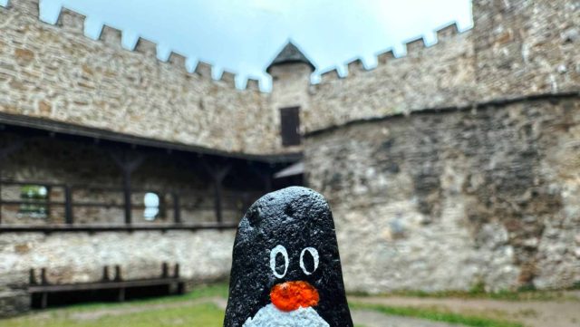 Hand-painted penguin stone #248 hidden at Castle Replica, Stara Lubovna, Slovakia