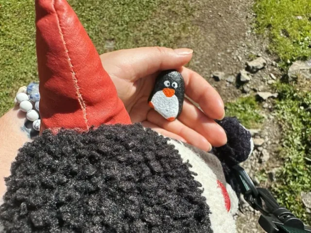 Hand-painted penguin stone #278 hidden at Bench, Oeschinen Lake, Switzerland (photo 5 of 5)