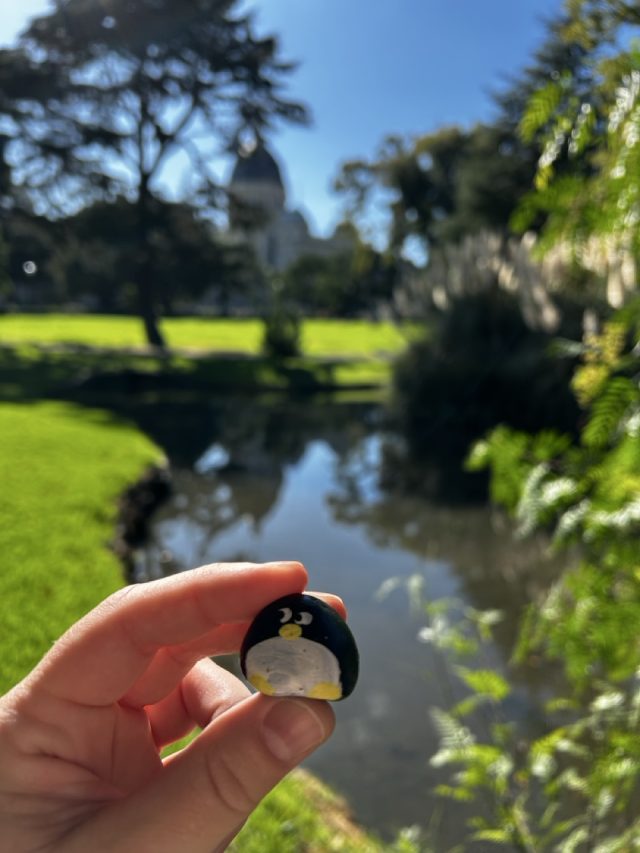 Hand-painted penguin stone #608 hidden at Carlton Gardens, Melbourne, Australia (photo 3 of 5)