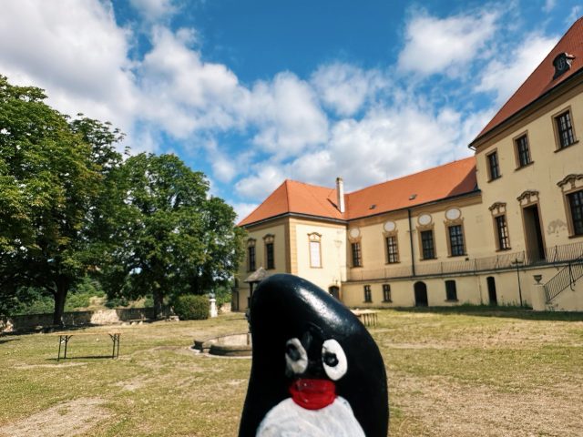 Hand-painted penguin stone #560 hidden at St. Nicholas' Deanery Church, Znojmo, Czechia (photo 2 of 5)