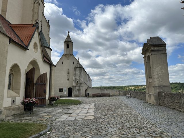Hand-painted penguin stone #560 hidden at St. Nicholas' Deanery Church, Znojmo, Czechia (photo 3 of 5)