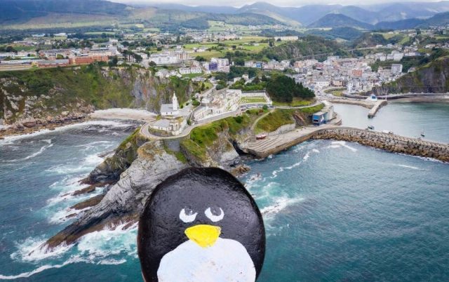 Hand-painted penguin stone #60 hidden at Faro de Luarca, Luarca, Spain