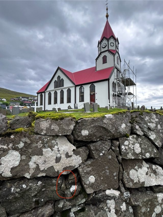 Hand-painted penguin stone #1066 hidden at Sandavags Kirkja, Sandavagur, Faroe Islands (photo 2 of 5)