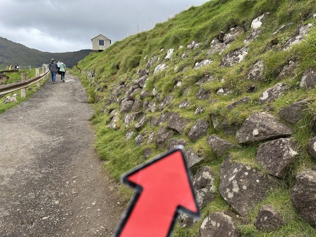 Hand-painted penguin stone #597 hidden at Mulafossur Waterfall, Gasadalur, Faroe Islands (photo 5 of 5)