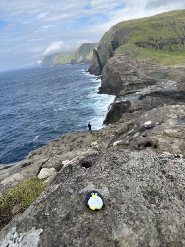 Hand-painted penguin stone #598 hidden at Bosdalafossur Waterfall, Sandavagur, Faroe Islands (photo 2 of 5)