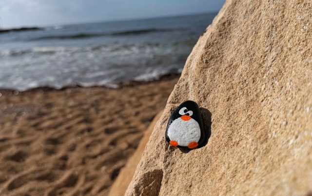 Hand-painted penguin stone #761 hidden at Louis Ledra Beach, Paphos, Cyprus