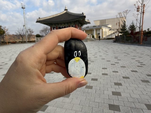 Hand-painted penguin stone #100 hidden at The Peace Bell, Gyeonggi-do, South Korea (photo 2 of 5)