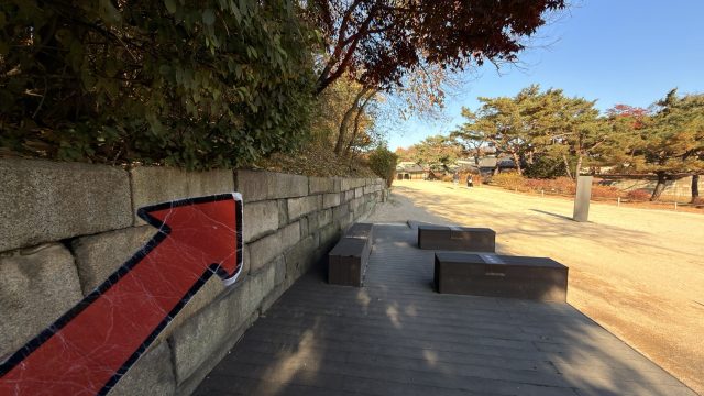 Hand-painted penguin stone #1414 hidden at Stone wall at Changdeokgung Palace, Seoul, South Korea (photo 4 of 5)