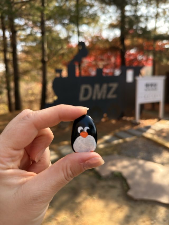 Hand-painted penguin stone #794 hidden at DMZ Sign, DMZ, South Korea (photo 2 of 5)