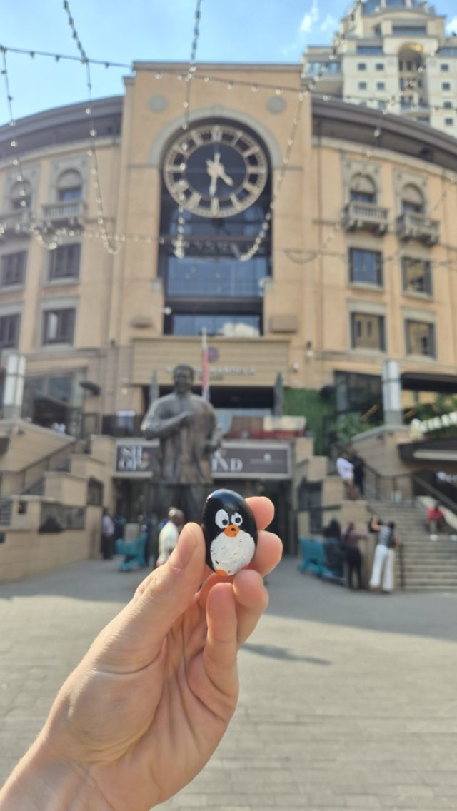 Hand-painted penguin stone #824 hidden at Nelson Mandela Square, Johannesburg, South Africa (photo 3 of 5)