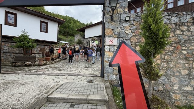 Hand-painted penguin stone #1179 hidden at Entrance Gate, Macedonian Village, North Macedonia (photo 4 of 4)