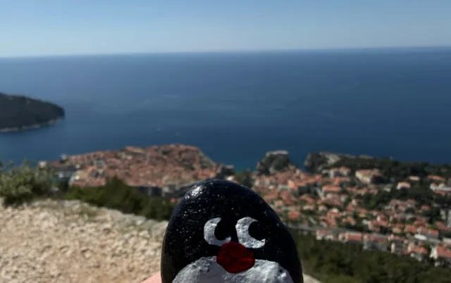 Hand-painted penguin stone #935 hidden at Dubrovnik Stations of the Cross XI, Dubrovnik, Croatia