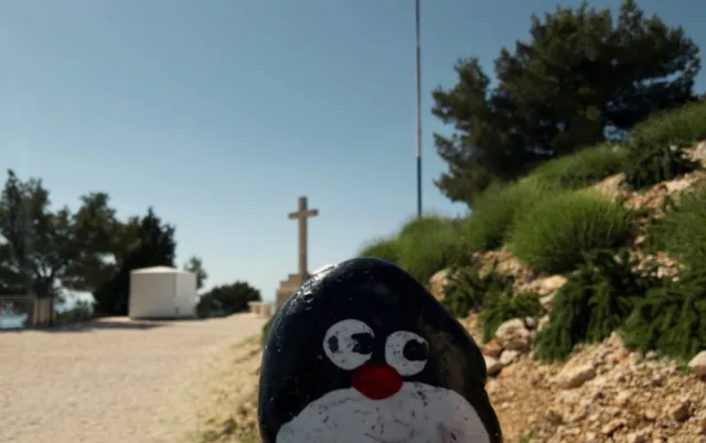 Hand-painted penguin stone #989 hidden at Rocks at Mount Srd, Dubrovnik, Croatia