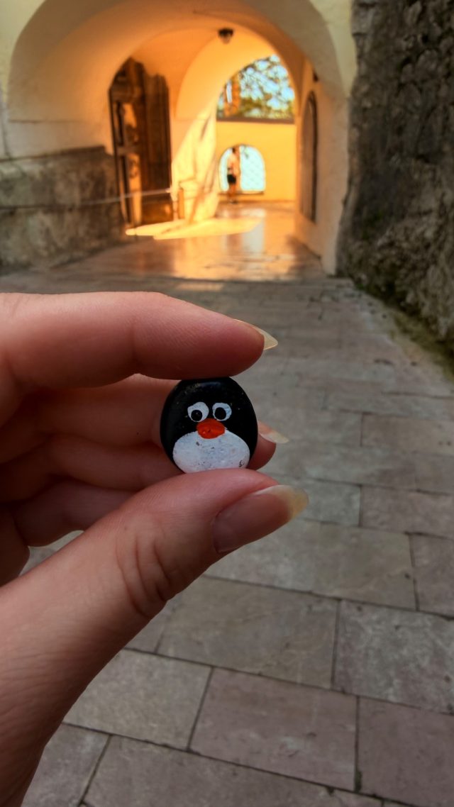 Hand-painted penguin stone #1162 hidden at St. Wolfgang Church, St. Wolfgang im Salzkammergut, Austria (photo 2 of 5)