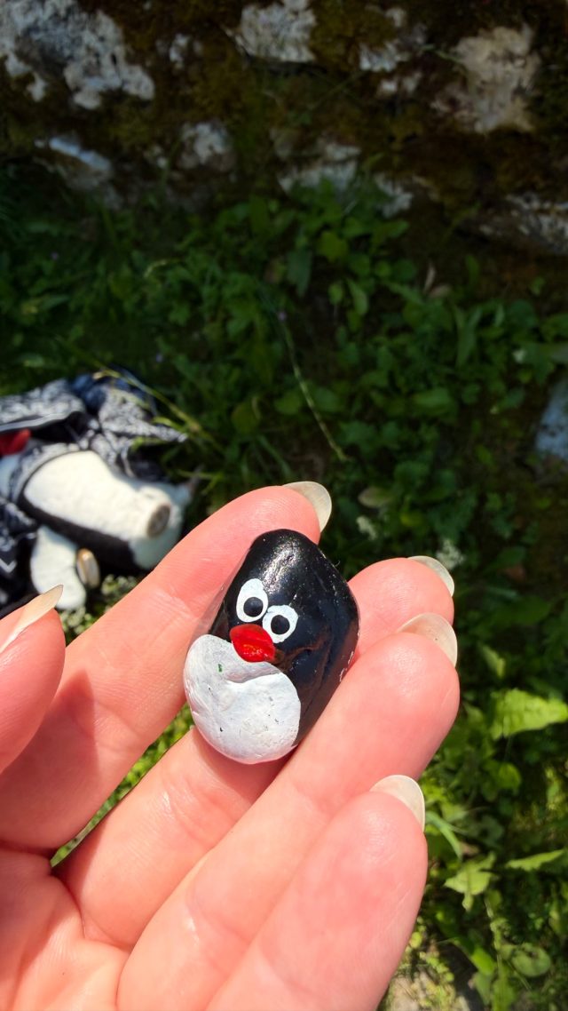 Hand-painted penguin stone #1260 hidden at Rocks next to water route,, St. Wolfgang im Salzkammergut, Austria (photo 4 of 5)