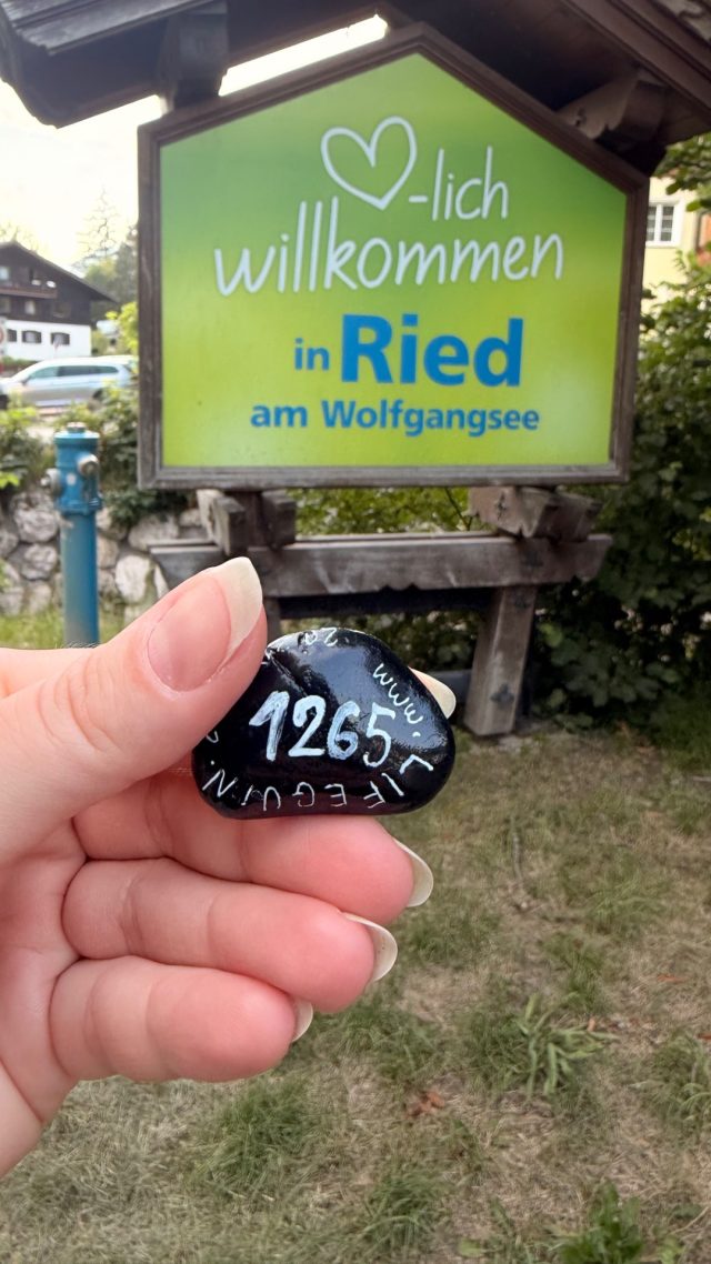 Hand-painted penguin stone #1265 hidden at Welcome in Ried Sign, St. Wolfgang im Salzkammergut, Austria (photo 2 of 5)