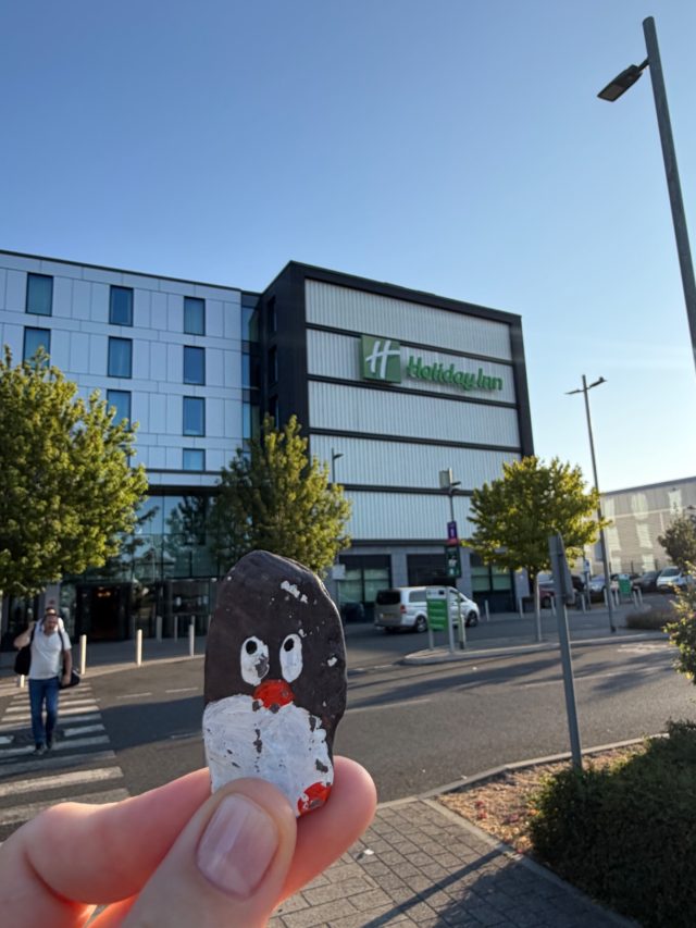 Hand-painted penguin stone #2319 hidden at Holiday In, Heathrow airport, Greater London, United Kingdom (photo 2 of 5)