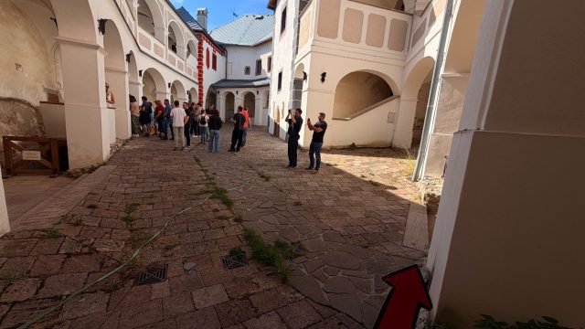 Hand-painted penguin stone #1123 hidden at Inner Courtyard of Lupca Castle, Slovenska Lupca, Slovakia (photo 2 of 5)