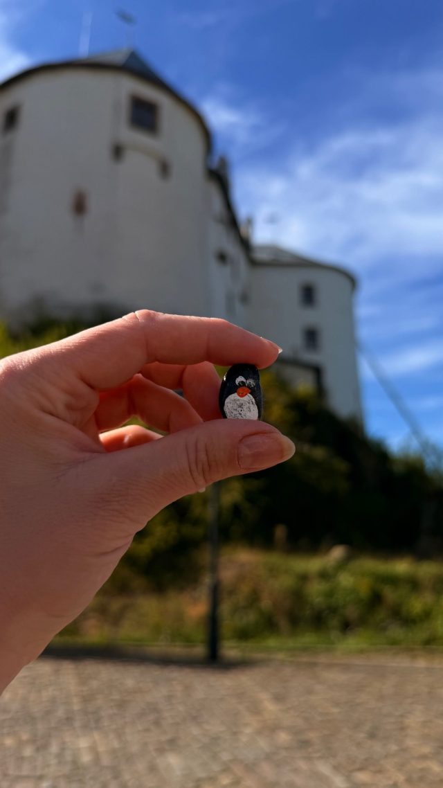 Hand-painted penguin stone #1135 hidden at Mathias Bel Statue at Lupca Castle, Slovenska Lupca, Slovakia (photo 3 of 5)