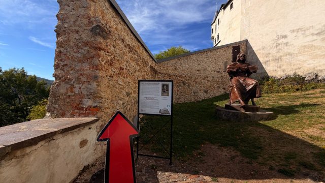 Hand-painted penguin stone #1135 hidden at Mathias Bel Statue at Lupca Castle, Slovenska Lupca, Slovakia (photo 5 of 5)