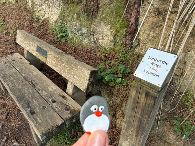 Hand-painted penguin stone #2325 hidden at Hobbit's Hideaway, Wellington, New Zealand