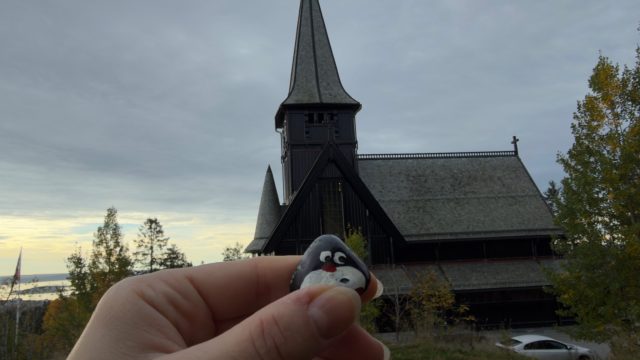 Hand-painted penguin stone #1238 hidden at Holmenkollen Chapel, Oslo, Norway