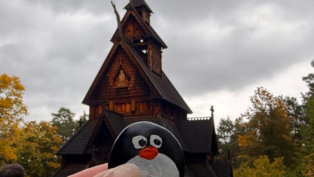 Hand-painted penguin stone #1493 hidden at The Stave Church from Gol, Oslo, Norway