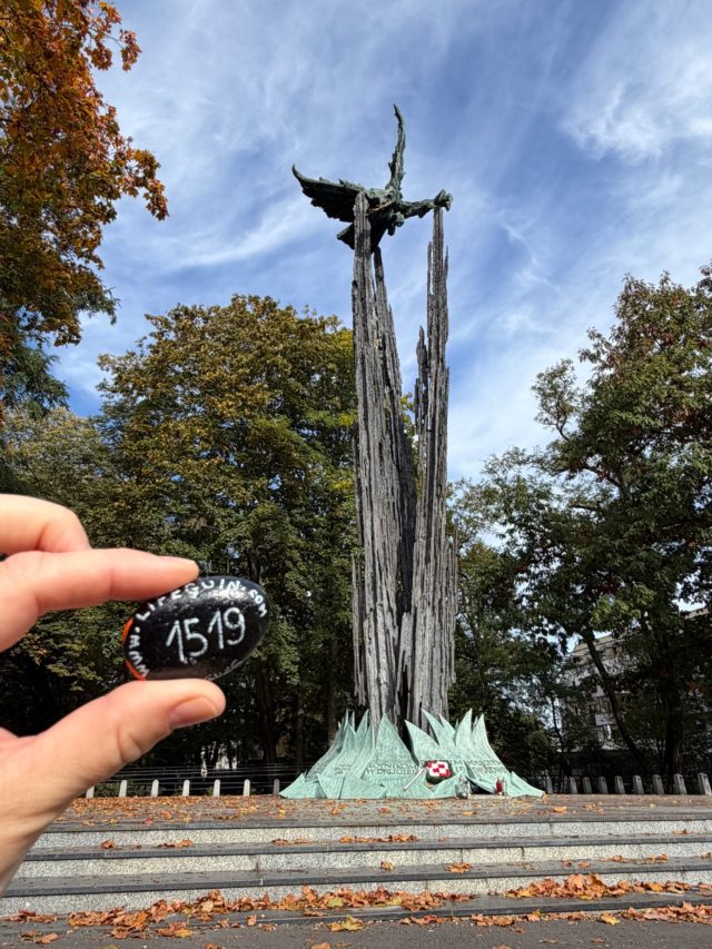 Hand-painted penguin stone #1519 hidden at Pomnik Lotnikow Polskich z 1989 r., Krakow, Poland (photo 2 of 5)