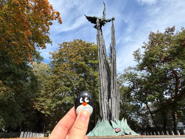 Hand-painted penguin stone #1519 hidden at Pomnik Lotnikow Polskich z 1989 r., Krakow, Poland