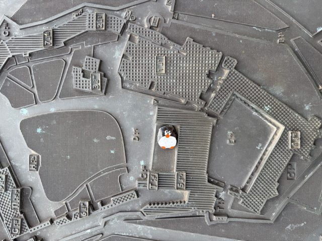 Hand-painted penguin stone #1526 hidden at Baszta Sandomierska, Krakow, Poland