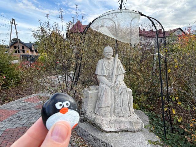 Hand-painted penguin stone #1542 hidden at Skwer Pamieci, Lubien, Poland