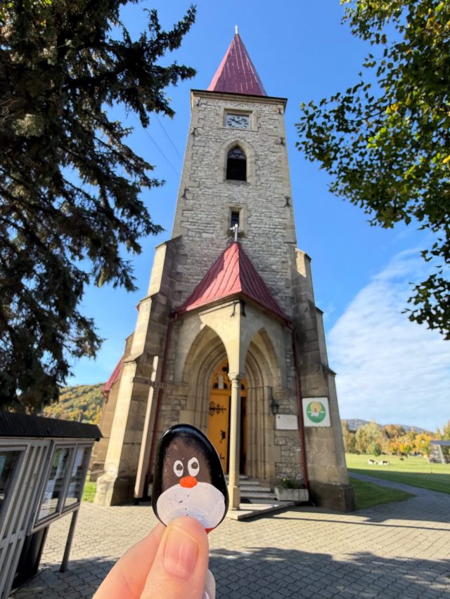 Hand-painted penguin stone #1569 hidden at Kostol sv. Michala archanjela, Sedliacka Dubova, Slovakia