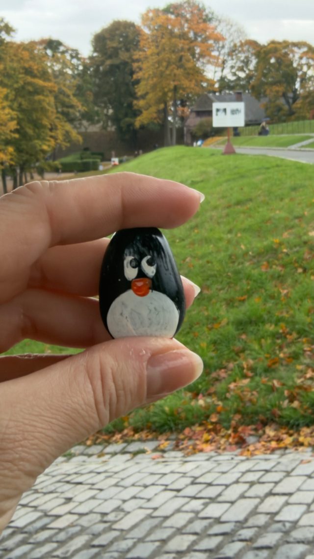 Hand-painted penguin stone #1572 hidden at Tree Trunk at Fortress, Oslo, Norway (photo 2 of 5)
