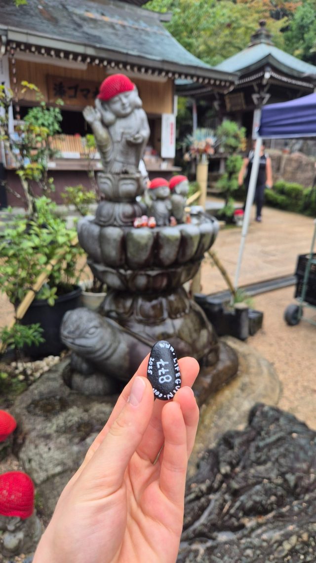 Hand-painted penguin stone #877 hidden at Gokurakukannon, Miyajima, Japan (photo 2 of 4)