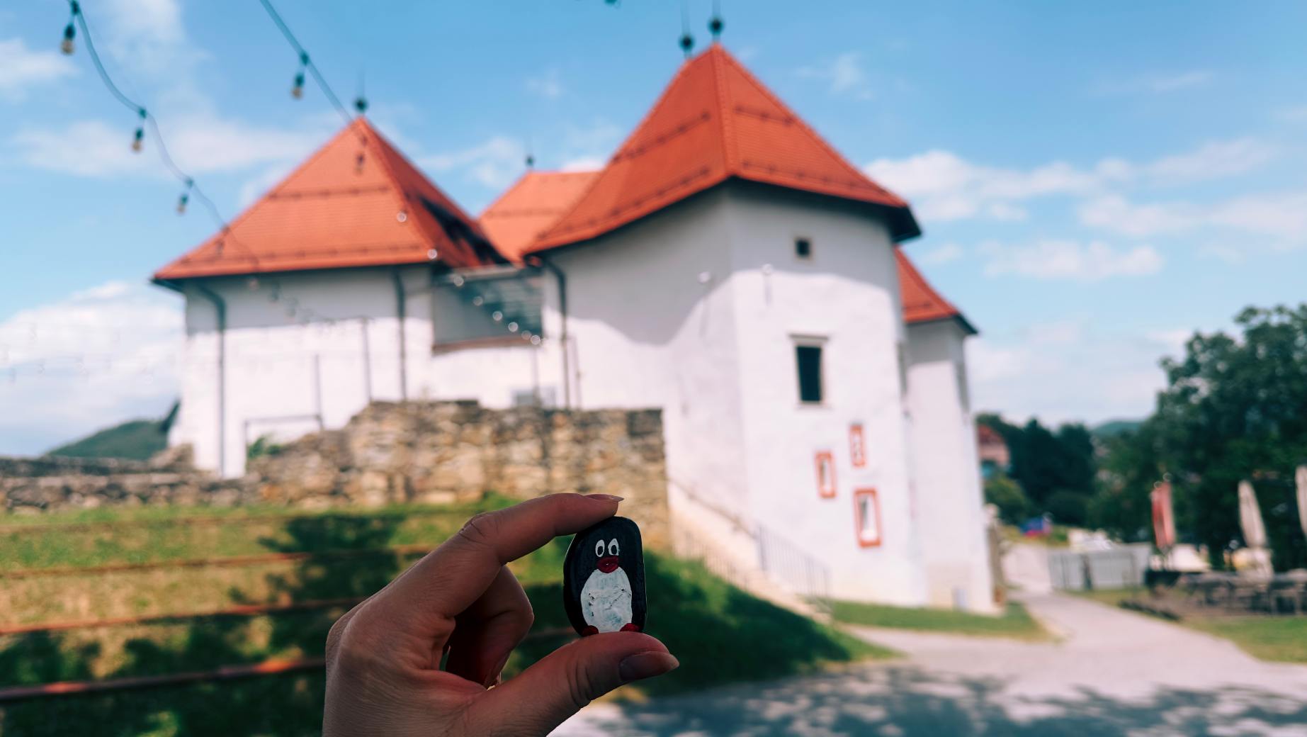 Hand-painted penguin stone #138 hidden at Komenda Castle, Polzela, Slovenia (photo 1 of 5)