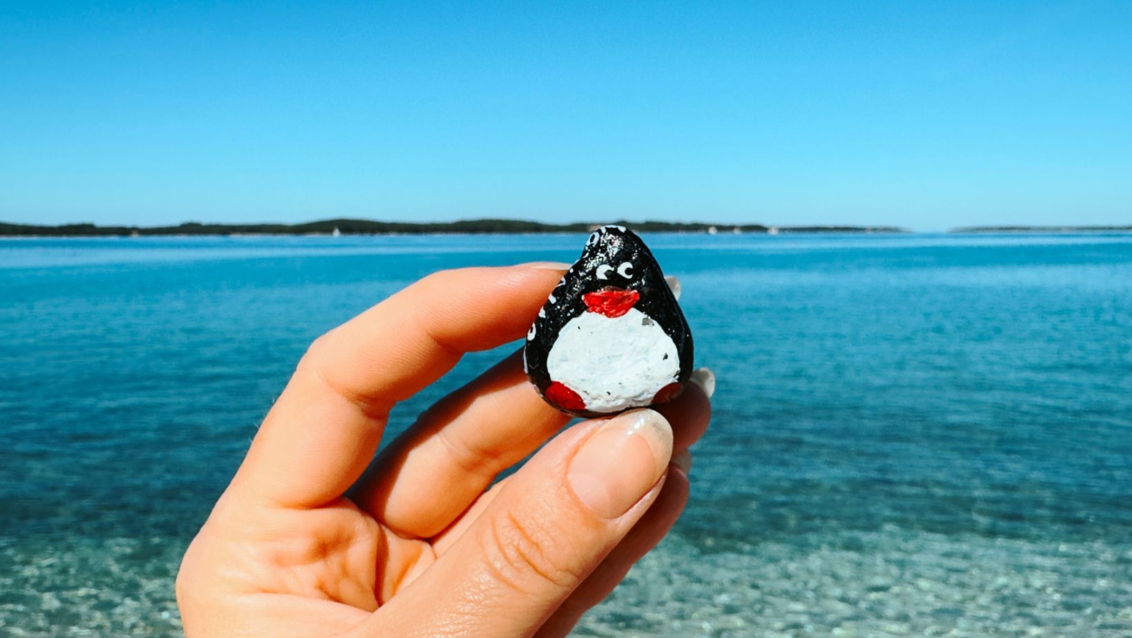 Hand-painted penguin stone #149 hidden at Church of Our Lady of Mount Carmel, Fazana, Croatia (photo 1 of 5)