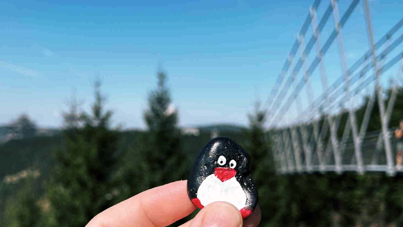 Hand-painted penguin stone #153 hidden at End of Sky Bridge 971, Morava, Czechia (photo 1 of 5)