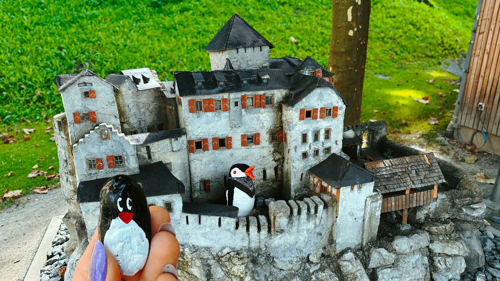 Hand-painted penguin stone #238 hidden at Castle Model, Vaduz, Liechtenstein (photo 1 of 5)