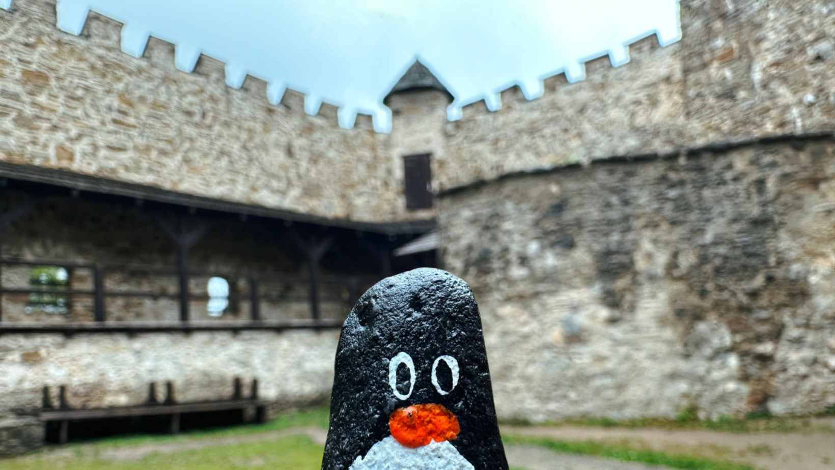 Hand-painted penguin stone #248 hidden at Castle Replica, Stara Lubovna, Slovakia (photo 1 of 5)