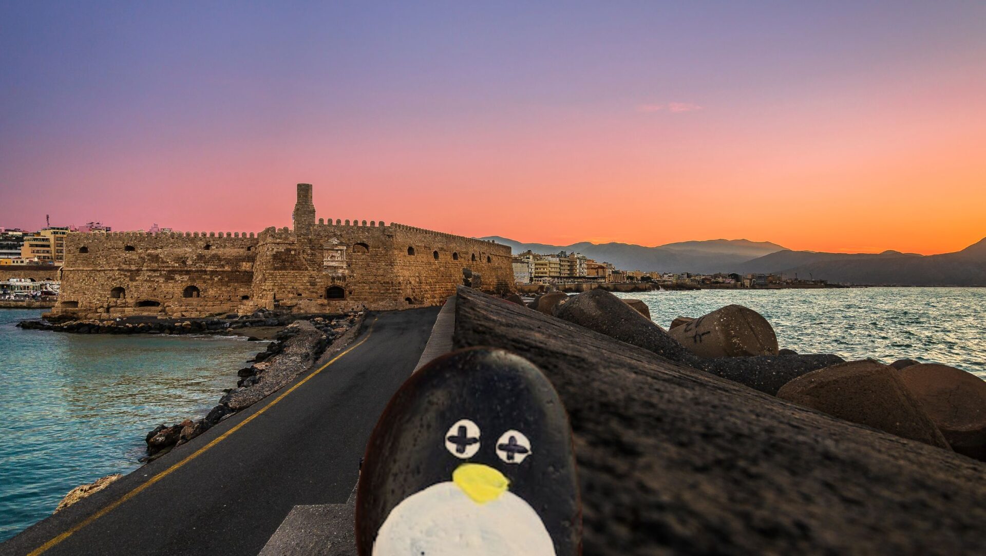 Hand-painted penguin stone #68 hidden at Rocca a Mare Fortress, Heraklion, Greece (photo 1 of 5)