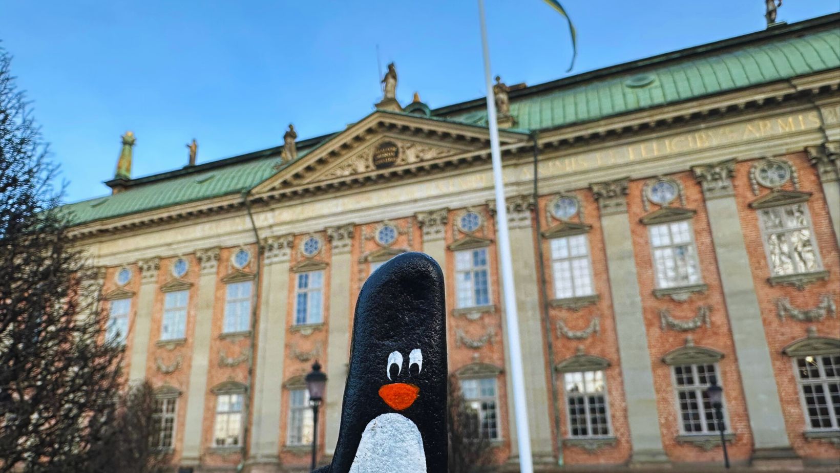 Hand-painted penguin stone #213 hidden at Riddarhuset (House of Nobility), Stockholm, Sweden (photo 1 of 5)