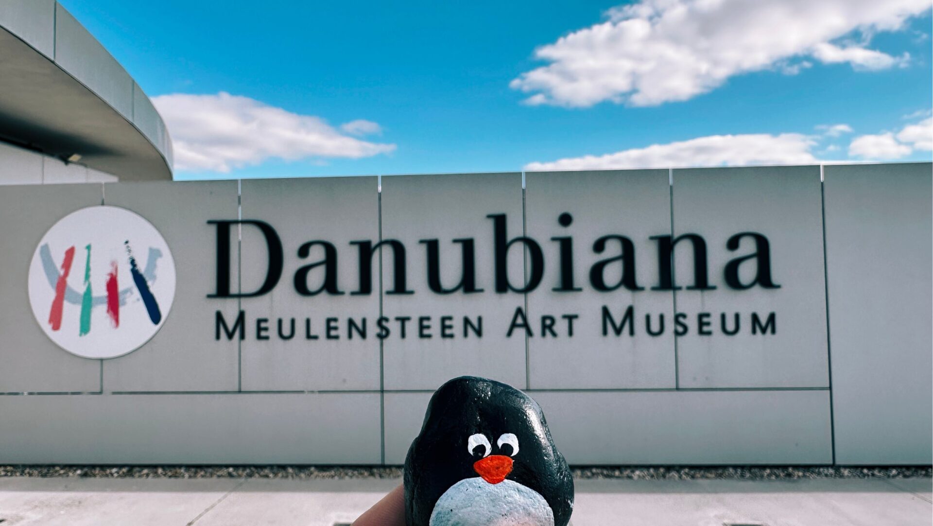 Hand-painted penguin stone #223 hidden at Danubiana, Cunovo, Slovakia (photo 1 of 5)