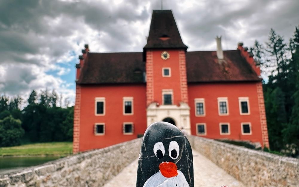 Hand-painted penguin stone #387 hidden at Cervena Lhota Castle, Jizna, Czechia (photo 1 of 5)